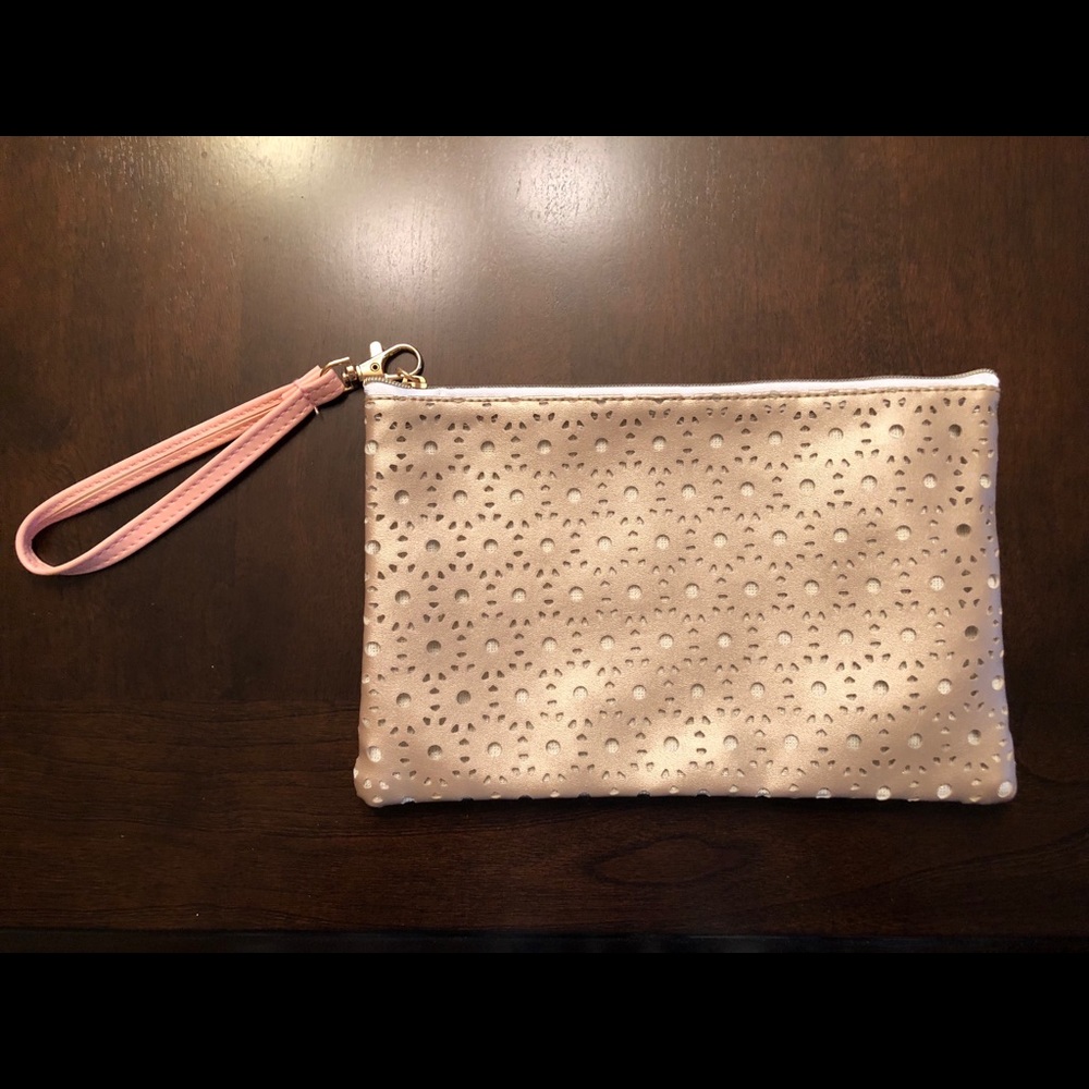 Gold cutout makeup bag with pink wrist strap